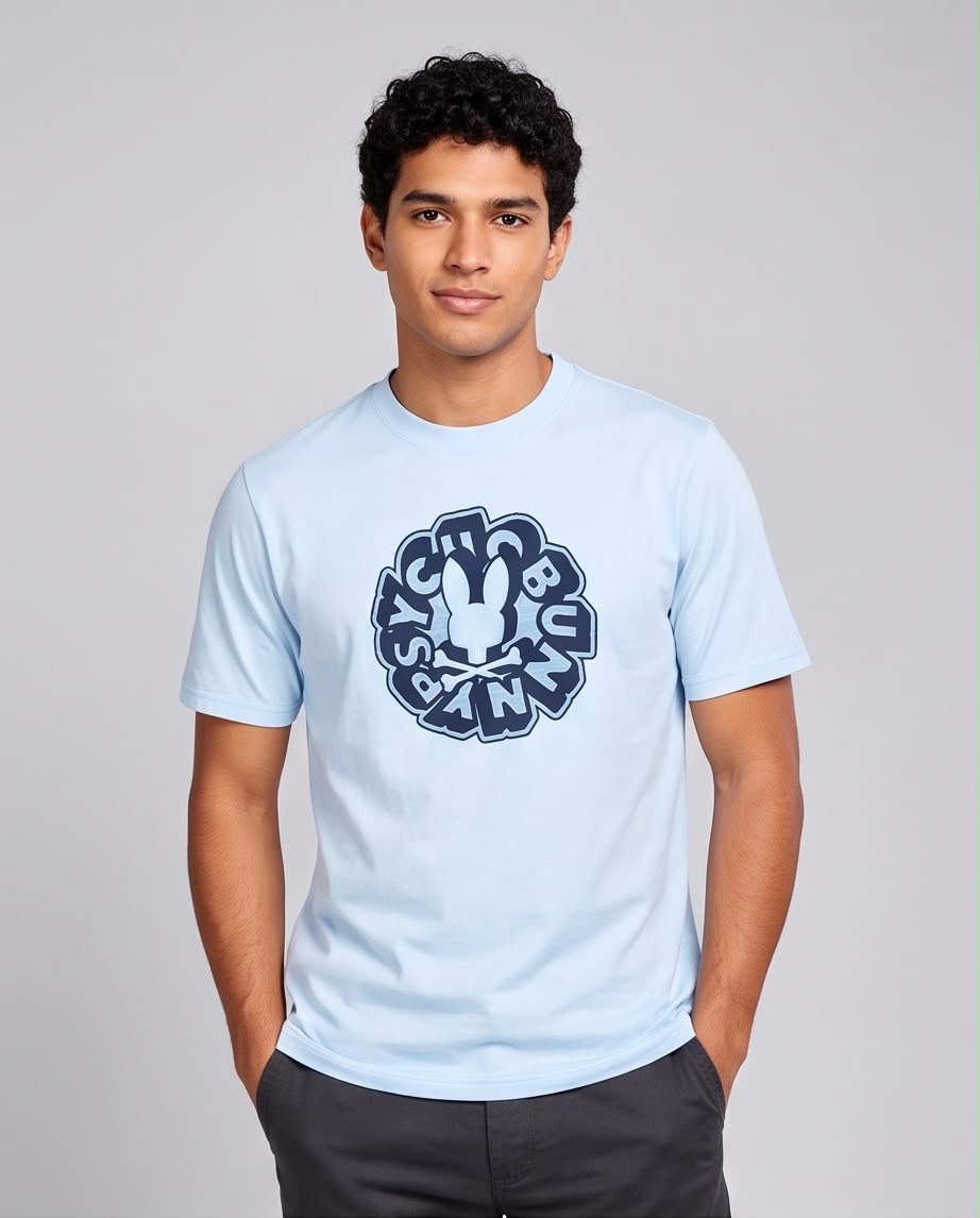 Camiseta azul claro con letras circulares y conejo central, modelo con manos en bolsillos