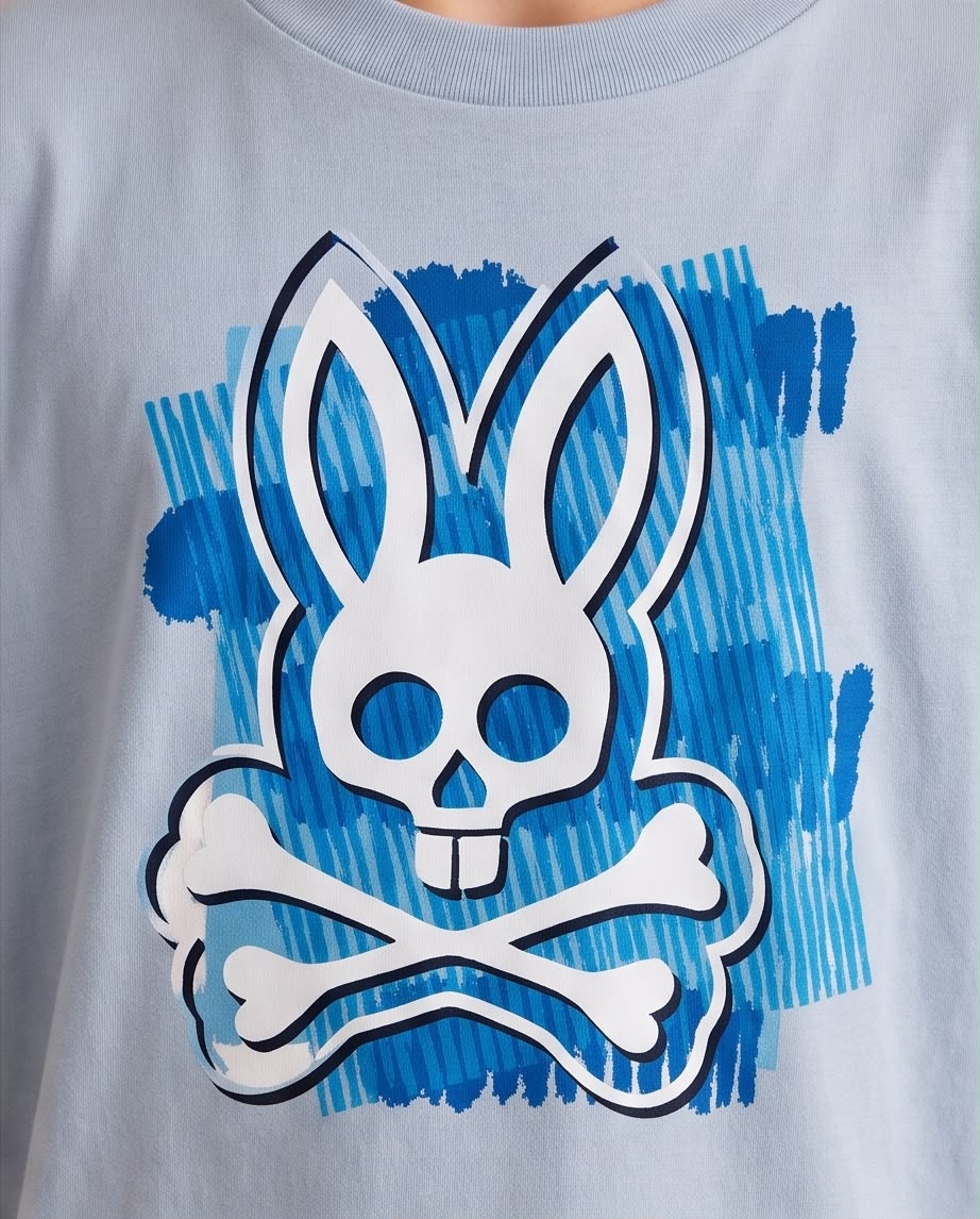 Camiseta Niño Psycho Bunny Calavera Blanca Pinceladas Azules Azul Cielo Semi Oversize